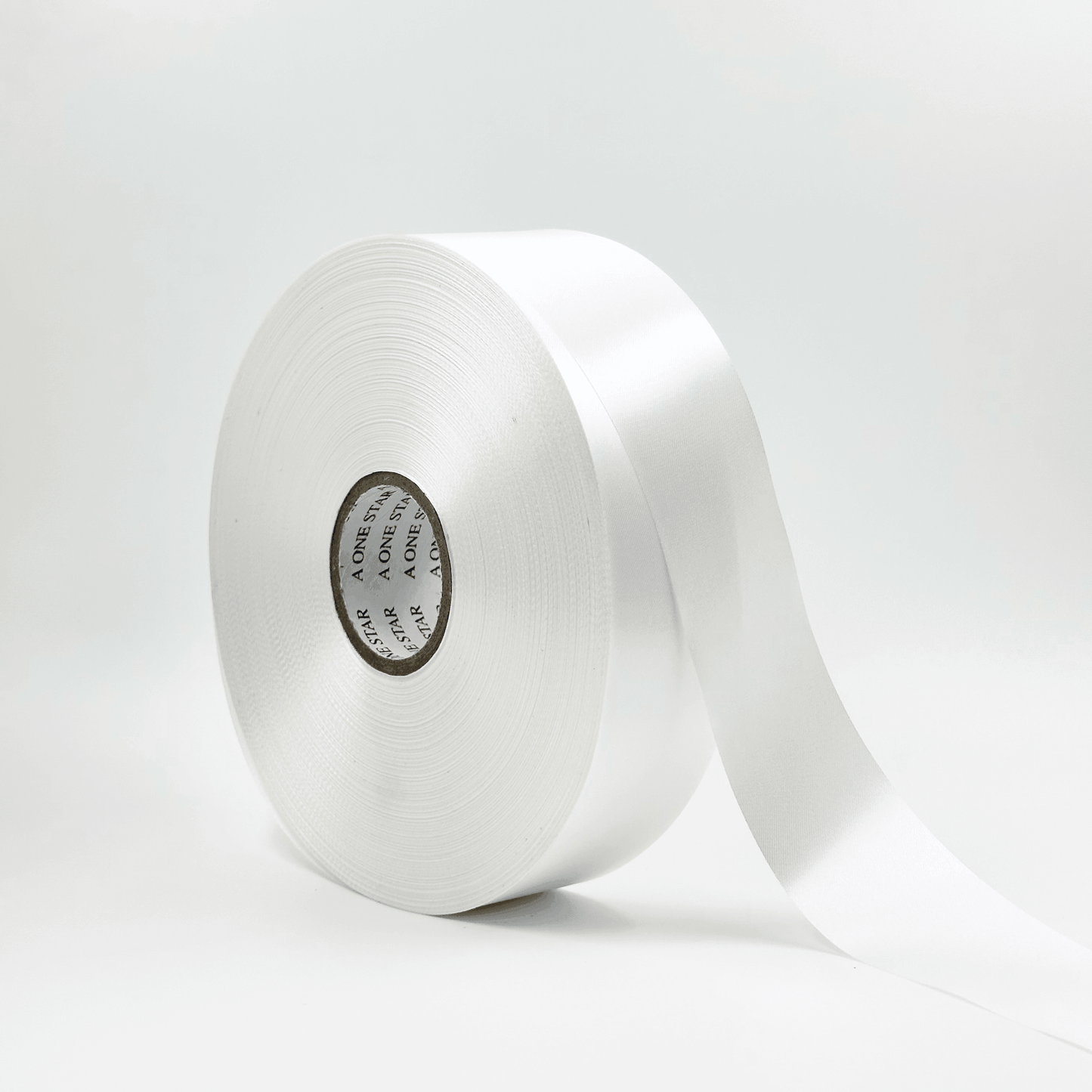 A roll of white satin ribbon