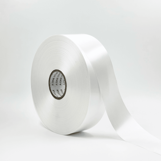 A roll of white satin ribbon